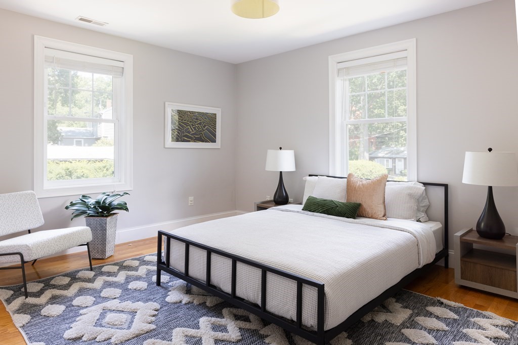 9 Hazel Terrace Arlington, MA 02474 - Photo 18 of 36 a bedroom with a bed and a lamp next to a window