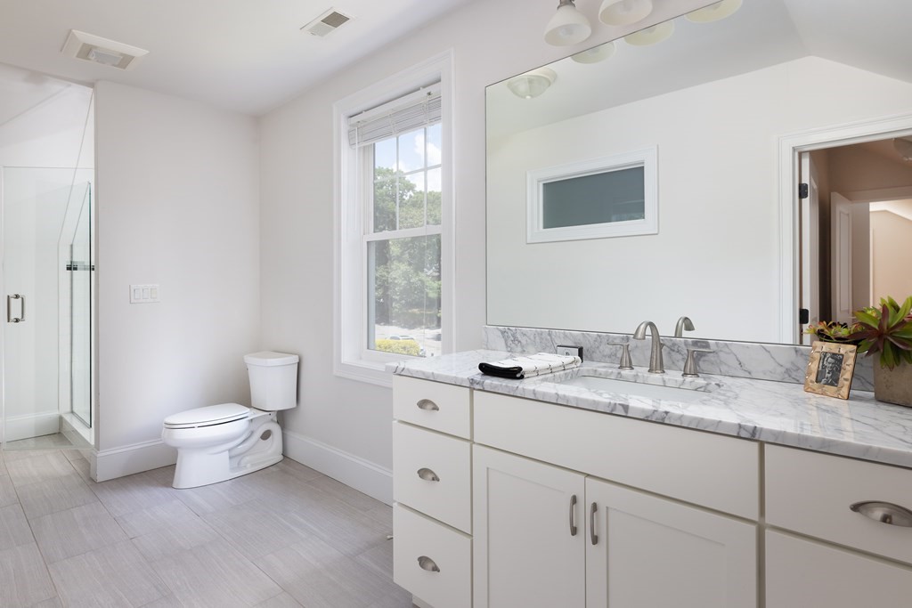 9 Hazel Terrace Arlington, MA 02474 - Photo 21 of 36 a bathroom with a granite countertop toilet sink and mirror