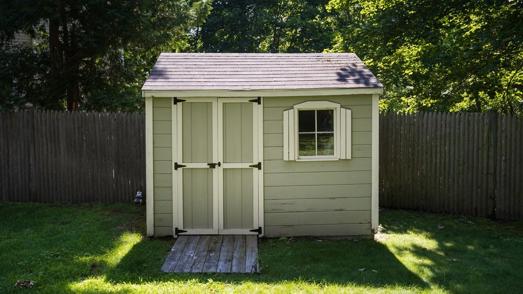9 Hazel Terrace Arlington, MA 02474 - Photo 31 of 36 a view of a house with a small yard and wooden fence