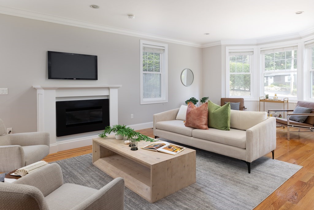 9 Hazel Terrace Arlington, MA 02474 - Photo 8 of 36 a living room with furniture a fireplace and a flat screen tv