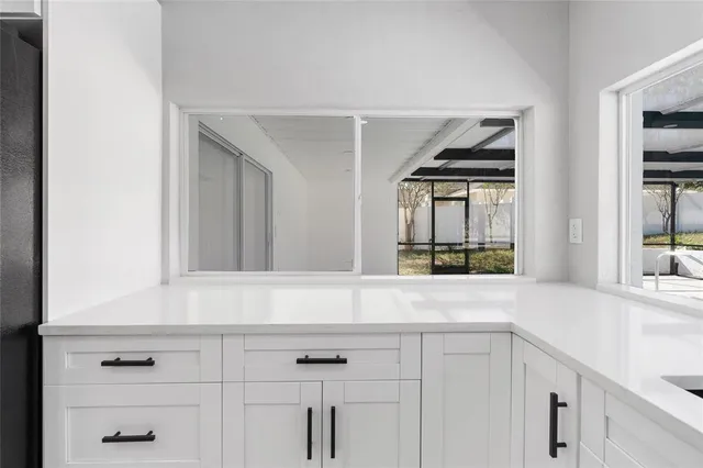 a view of white cabinets and a window