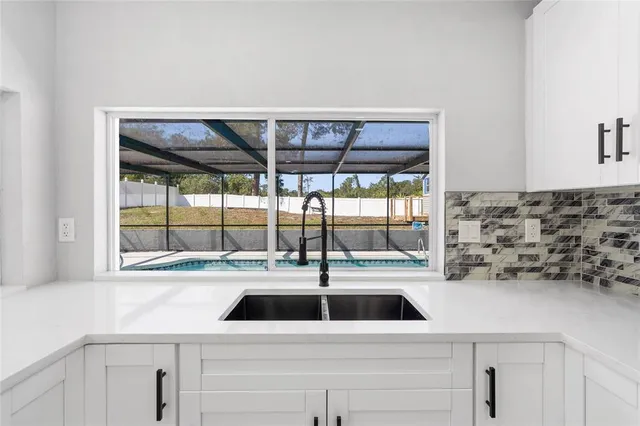 a kitchen with a sink and large window