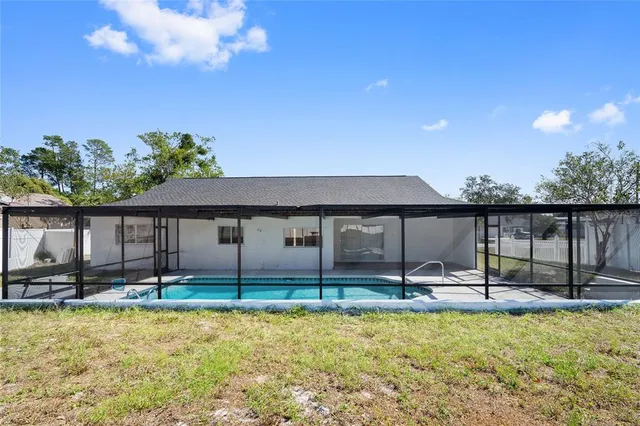 a backyard of a house with table and chairs