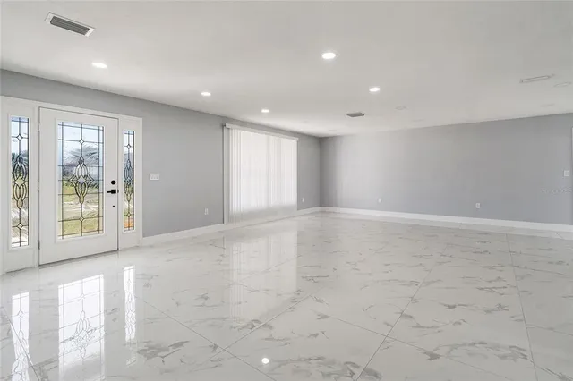 a view of an empty room with glass door