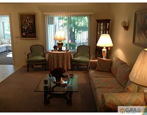 273 B Convent Road Monroe Township, NJ 08831 - Photo 7 of 15 a living room with furniture and a lamp