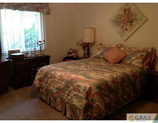 273 B Convent Road Monroe Township, NJ 08831 - Photo 8 of 15 a bed sitting in a bedroom next to a window