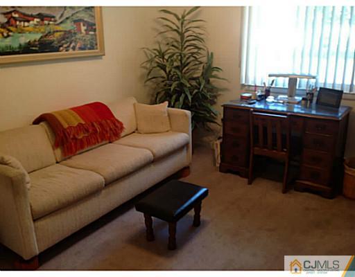 273 B Convent Road Monroe Township, NJ 08831 - Photo 10 of 15 a living room with furniture and a lamp