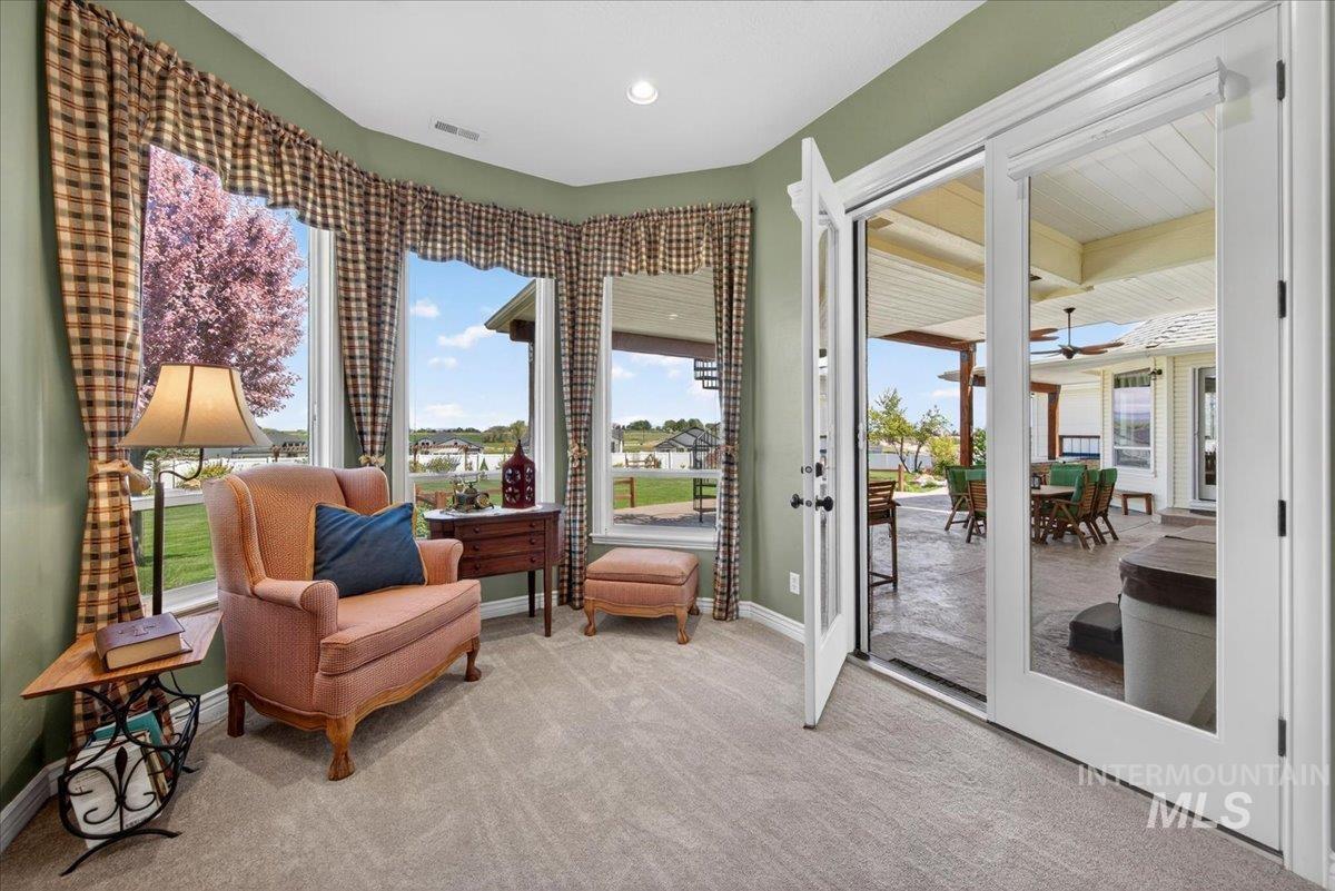 414 East Shafer View Drive Meridian, ID 83642 - Photo 19 of 50 Bayed Sitting area with multiple large windows and direct access to a covered outdoor patio with Jacuzzi Hot Tub via glass French doors!