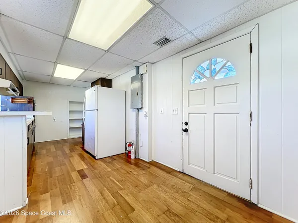 a view of empty room with wooden floor