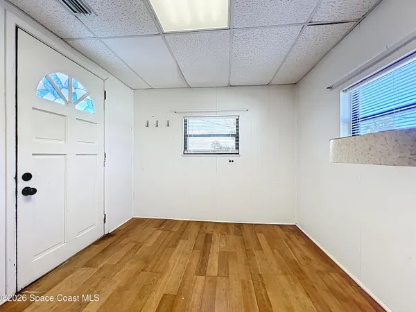 a view of a room with wooden floor
