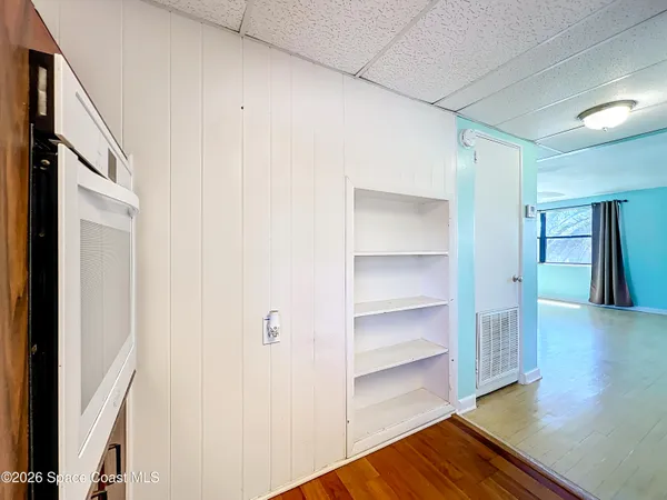 a view of a hallway with wooden floor