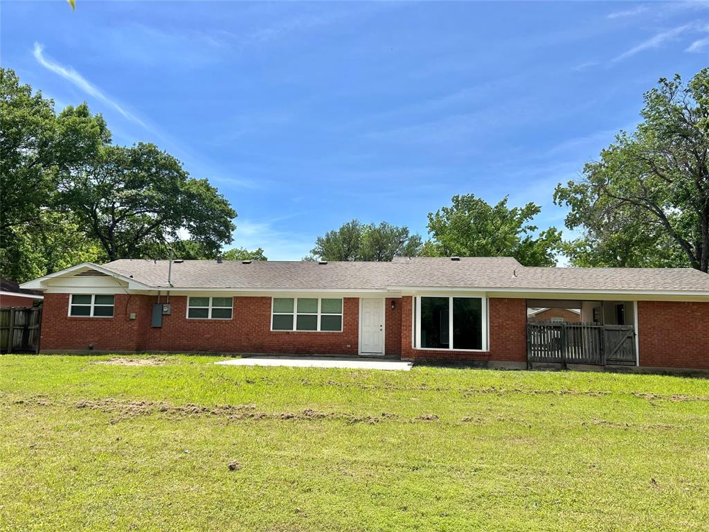 306 Line Drive Gainesville, TX 76240 - Photo 3 of 21 a front view of a house with a garden