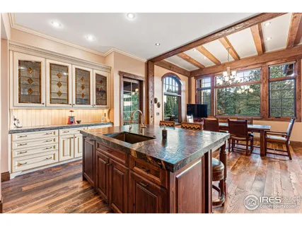 a kitchen with a stove a sink and a wooden floors