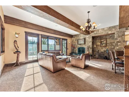 a living room with fireplace furniture and a chandelier