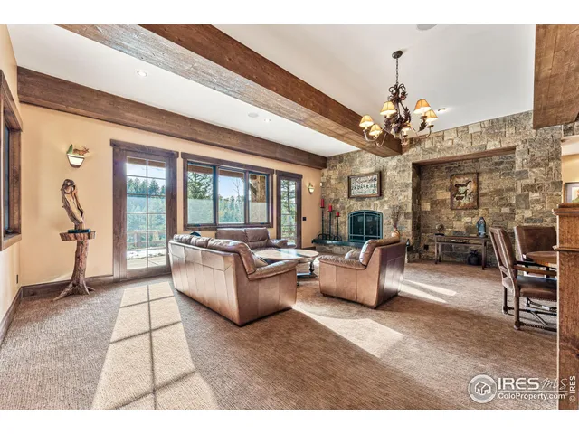 a living room with fireplace furniture and a chandelier