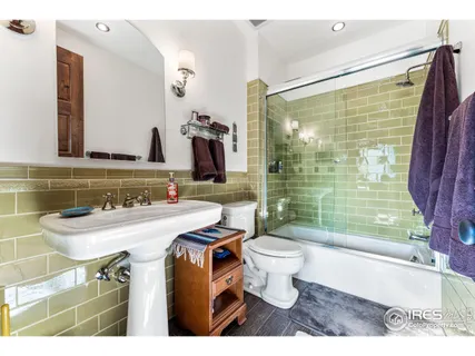 a bedroom with two beds and a large window