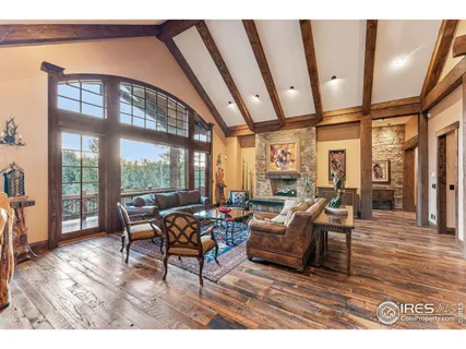 a living room with furniture and a floor to ceiling window