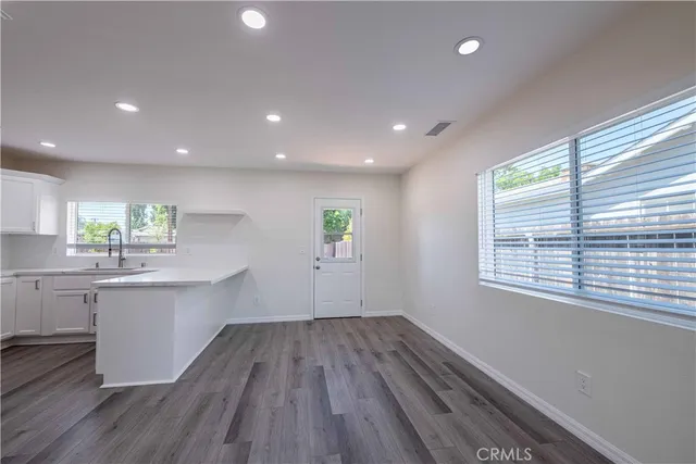 a kitchen with a wooden floor and window