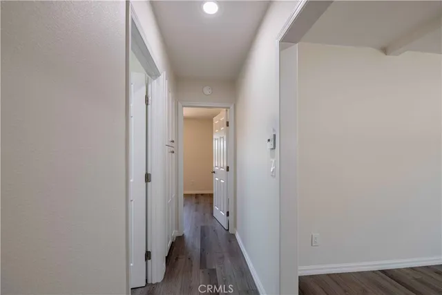 a view of a hallway with a wooden floor