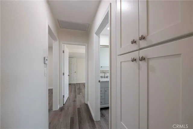 en empty room with wooden floor and windows