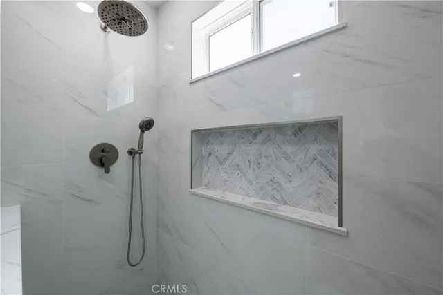 a view of an empty room with a fireplace and a window