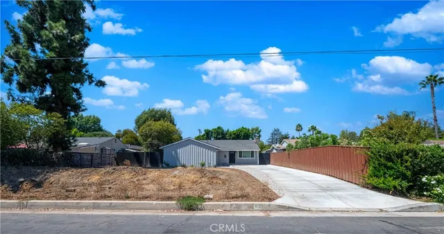 a pathway of a house with a yard
