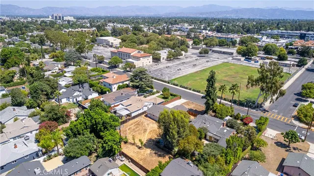 an aerial view of a houses with a swimming pool