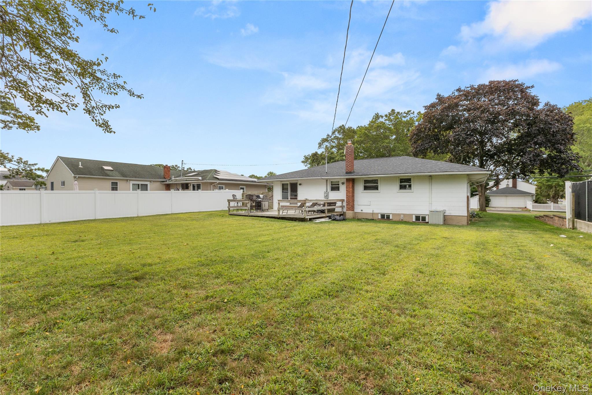 205 Timber Point Road East Islip, NY 11730 - Photo 12 of 16 Rear view of property with a wooden deck and a chimney