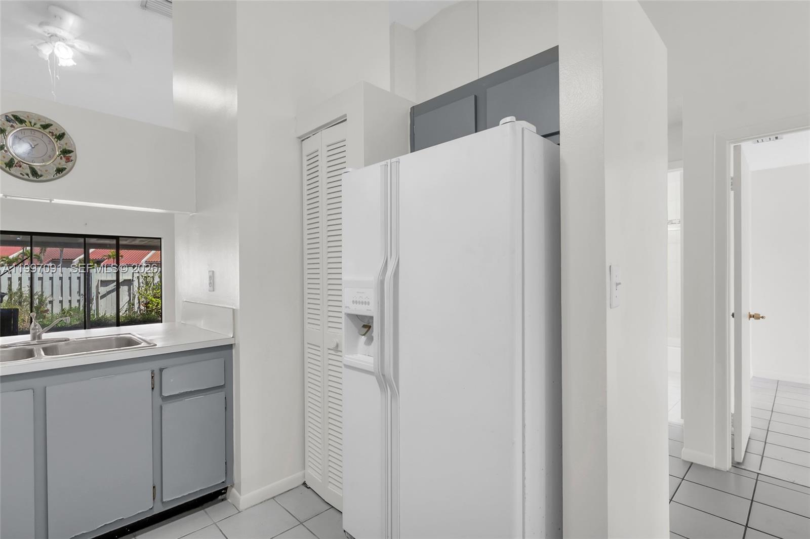 6323 Southwest 147th Pl Circle Miami, FL 33193 - Photo 11 of 29 a kitchen with a refrigerator and a sink