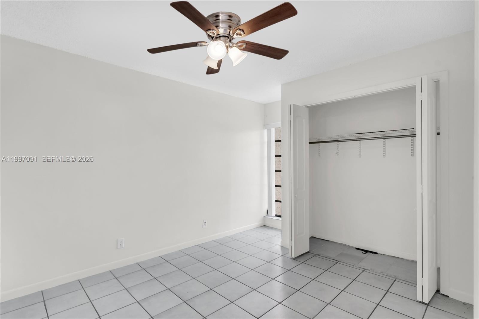 6323 Southwest 147th Pl Circle Miami, FL 33193 - Photo 13 of 29 an empty room with chandelier fan
