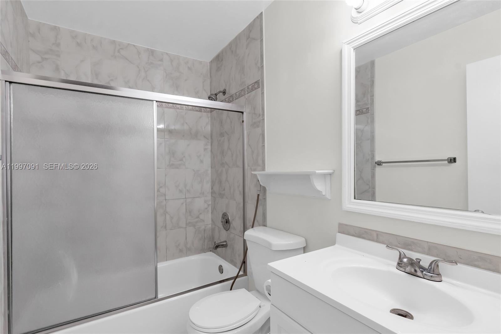 6323 Southwest 147th Pl Circle Miami, FL 33193 - Photo 20 of 29 a bathroom with a sink toilet and shower