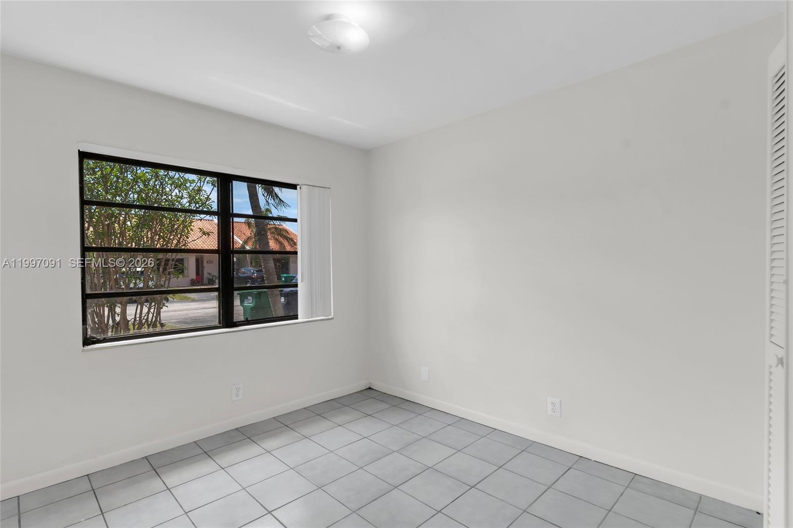 6323 Southwest 147th Pl Circle Miami, FL 33193 - Photo 21 of 29 an empty room with windows