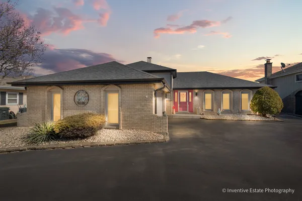 a front view of a house with a garden