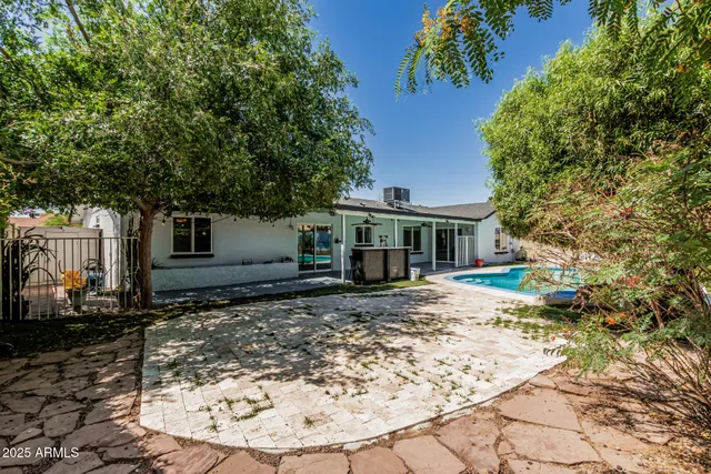 a bathroom with a granite countertop sink a toilet and a mirror