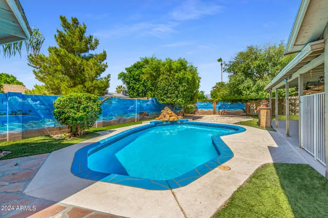 a view of a swimming pool with a yard