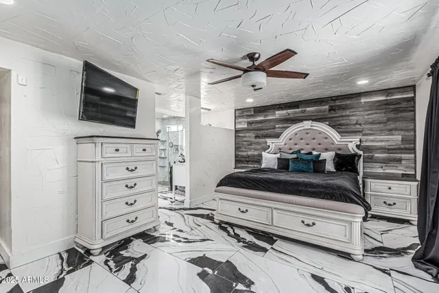 a bathroom with a granite countertop sink a mirror and shower