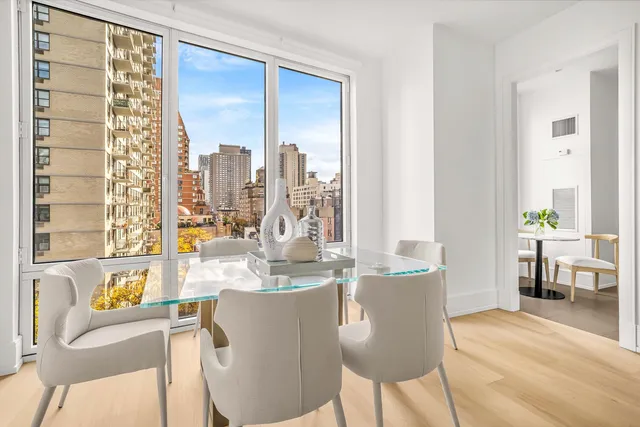 a dining room with furniture a window and a kitchen view