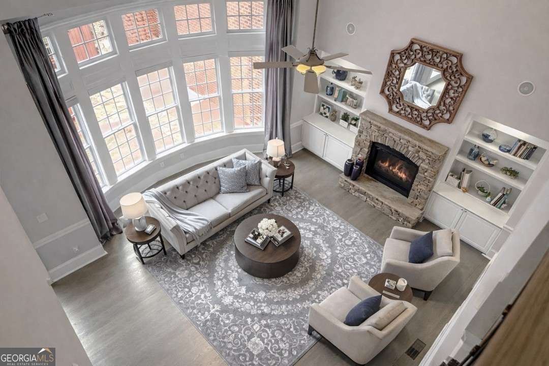 4738 Southeast Ivy Ridge Drive Southeast Atlanta, GA 30339 - Photo 1 of 1 a living room with furniture a fireplace and a floor to ceiling window