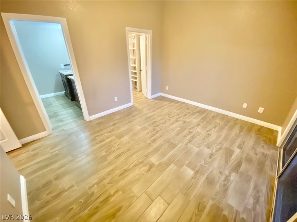 2000 Turquoise Ridge Street, Unit 204 Las Vegas, NV 89117 - Photo 3 of 29 Natural wood-look tile flooring flows throughout this versatile space, connecting to a walk-in closet.