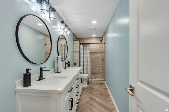 2194 Autumn Drive Mapleton, UT 84664 - Photo 14 of 41 Dual vanity with white cabinetry, matte black hardware, and round mirrors