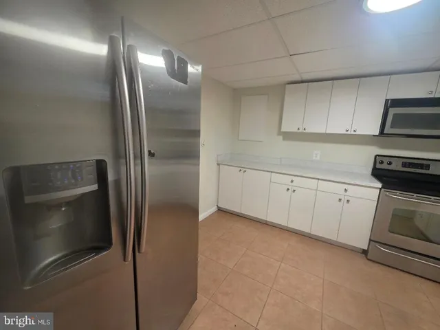 a kitchen with cabinets and stainless steel appliances