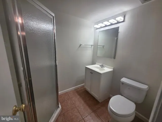 a white toilet sitting next to a bathroom sink
