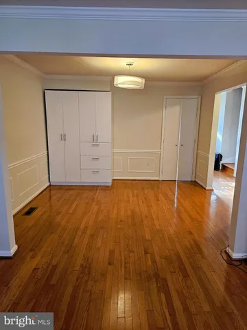a view of a room with wooden floor