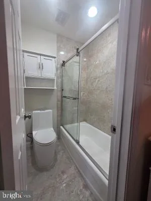 a bathroom with a toilet and a shower