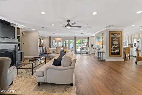 a living room with furniture kitchen view and a table