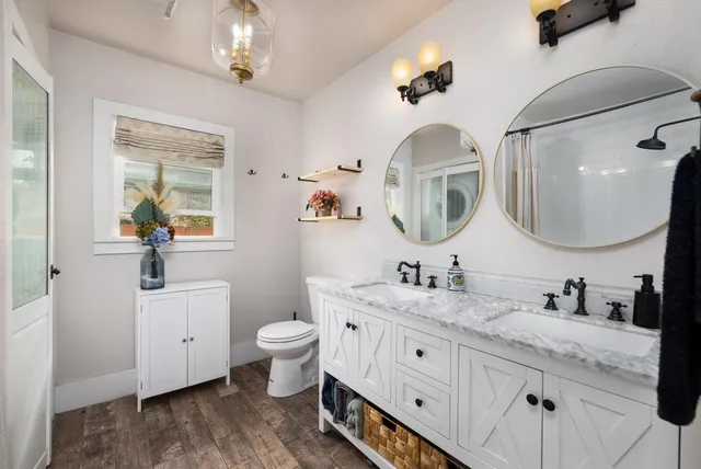 a bathroom with a double vanity sink and a mirror