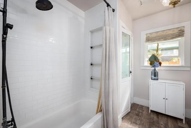 a bathroom with a bathtub and a shower