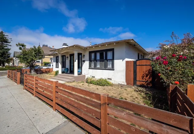 a view of a house with wooden fence