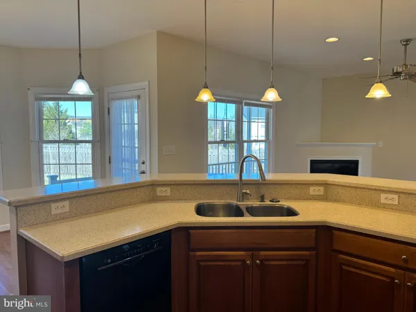 a kitchen with a sink a counter and windows