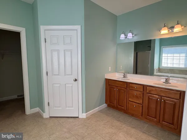 a spacious bathroom with a double vanity sink and a mirror